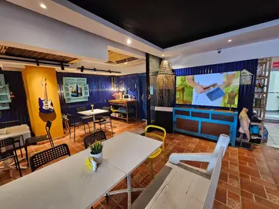 a room with a table and a large screen at Apartamento frente al Mar y Piscina in Juan Dolio