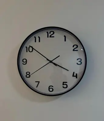 a clock is hanging on a wall at Apartamento en livera RD in Santiago de los Caballeros