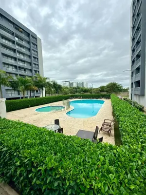 a swimming pool in a resort with two buildings at Apartamento en livera RD in Santiago de los Caballeros