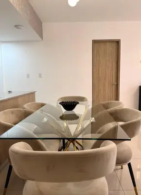 a dining room with a glass table and chairs at Apartamento en livera RD in Santiago de los Caballeros