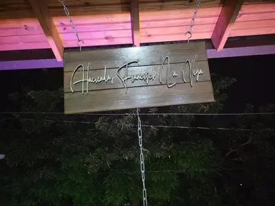 a wooden sign with writing on it under a roof at Hacienda Francisco in Concepción de La Vega