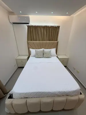 a bedroom with a large white bed with two pillows at Piscina Playa 3 Min Aeropuerto Cerca in Boca Chica