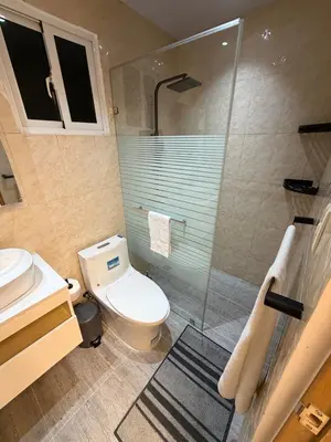 a bathroom with a toilet and a glass shower at Piscina Playa 3 Min Aeropuerto Cerca in Boca Chica