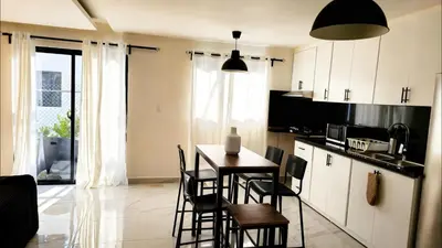 a kitchen with a table and chairs in a room at Villa Brisa Marina in Boca Chica