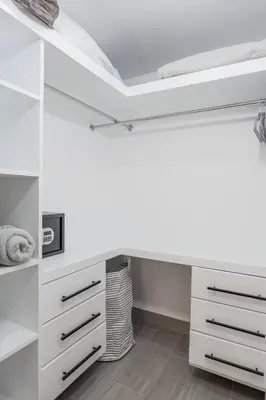a white bedroom with a desk and drawers at Nestled Comfort in 1BR -WeHost DR in Santo Domingo