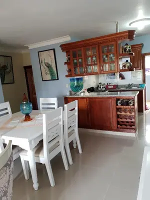 a kitchen with a white table and white chairs at My house 56 in San Francisco de Macorís