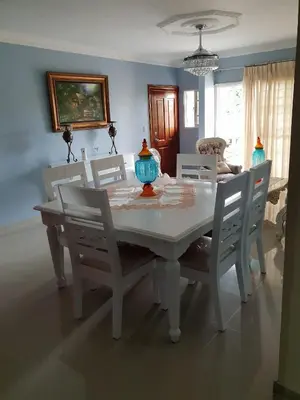 a white dining room table with chairs and a vase on it at My house 56 in San Francisco de Macorís
