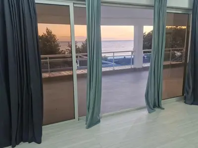 a room with a window with a view of the ocean at Oceanfront villa with pool, Ocoa bay in Azua