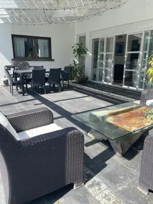 a patio with chairs and a table and a table and chairs at Villa exotic in Juan Dolio