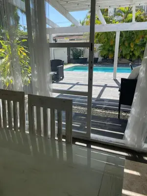 a view of the pool from the porch of a house at Villa exotic in Juan Dolio