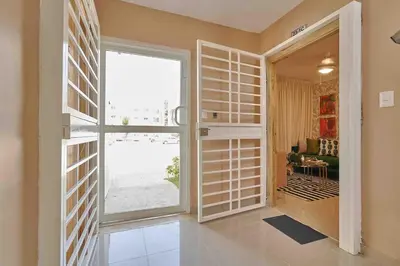 a hallway with a large window and a living room at ®{The-Comfty-Spot} Experience @SD WiFi in Santo Domingo