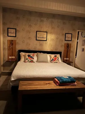 a bedroom with a bed and a wooden table at Monte y Cielo 1 apartment in Las Galeras