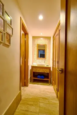a hallway with a room with a sink and a mirror at ®2BR{Beach~Spot} @TerrenasJaccuziWalk~to~Beach in El Limón