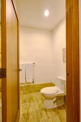 a bathroom with a white toilet in a room at ®2BR{Beach~Spot} @TerrenasJaccuziWalk~to~Beach in El Limón