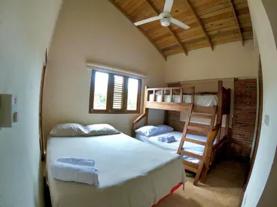 a bedroom with a bed and a bunk bed at Villa 3 Habitaciones con piscina in Jarabacoa