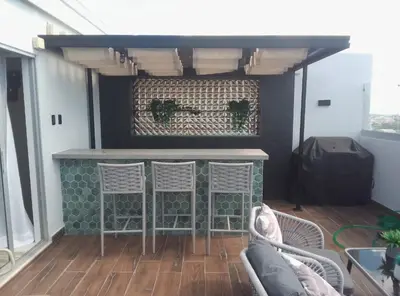 a bar on the back of a house with two chairs at Sky 01 M11 in Santo Domingo