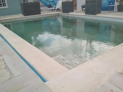 a pool of water in the middle of a house at Brisa del mar in Boca Chica