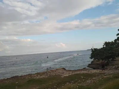 a group of people in the water at a beach at Brisa del mar in Boca Chica