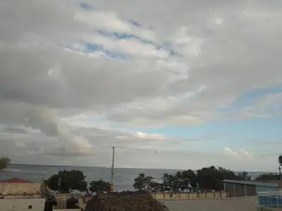 a cloudy sky with the ocean in the background at Brisa del mar in Boca Chica