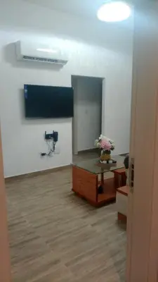 a room with a mirror and a desk with flowers at Comfortable oceanfront apartment on Av España in La Francia