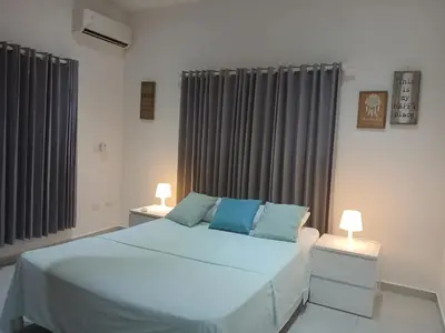 a bedroom with a large bed with two night stands at Cultrera 1 in Las Terrenas