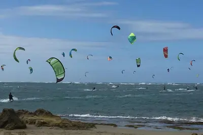 a group of people kite surfing in the ocean at Villa Dawn, Bahia de Arena in Cabarete