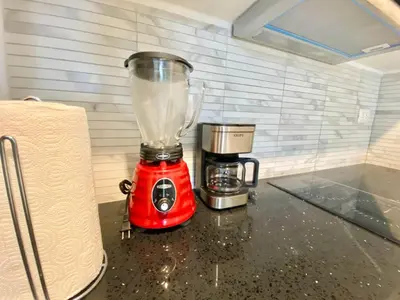a red blender sitting on top of a counter at 1B Fantasy Lodge @t Canabay Private Pool and beach in Punta Cana