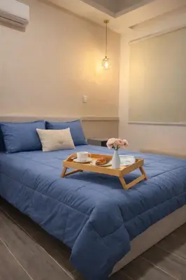 a blue couch with a coffee table on it at Modern Luxury Apt Pool, Gym and Prime Location in La Julia