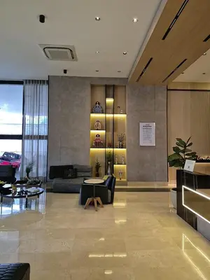 a living room with a couch and a table at Modern Luxury Apt Pool, Gym and Prime Location in La Julia