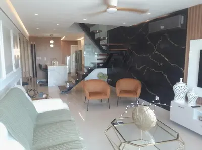 a living room with two chairs and a staircase at Sky 01 M10 in Santo Domingo