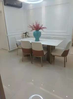a table with chairs and a vase with flowers on it at Sky 01 M10 in Santo Domingo