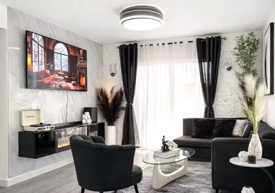 a living room with a couch and a tv at Comfy & Secure Modern 2BR Apartment just 5 minutes from Airport in Boca Chica in Boca Chica