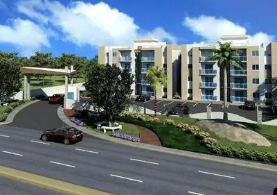 a car driving down a road next to a building at Comfy & Secure Modern 2BR Apartment just 5 minutes from Airport in Boca Chica in Boca Chica