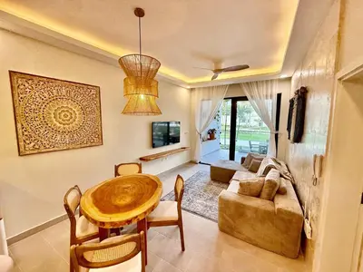a living room with a table and a couch at Stunning oceanfront apartment in Encuentro at The Wave in Cabarete