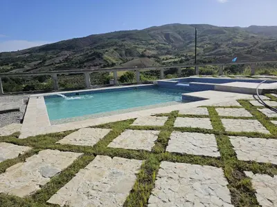 a swimming pool with a mountain in the background at Alto Nuevo