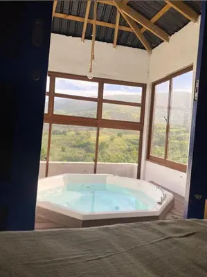 a large bath tub in a room with a window at Alto Nuevo