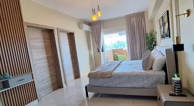 a bedroom with a bed and a large window at Exclusive apartment in SDE in Juan López