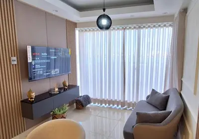 a living room with a couch and a tv and a window at Exclusive apartment in SDE in Juan López