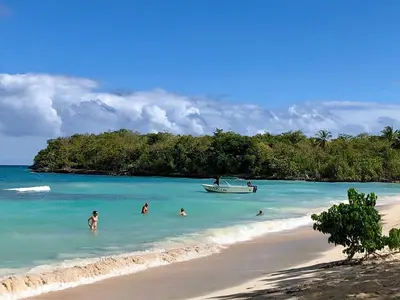 a group of people in the water on a beach at Comfortable stay for 4 people in Las Galeras