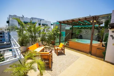 a patio with chairs and a swimming pool on a building at Luxury Caribbean penthouse in Santo Domingo
