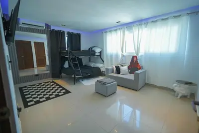 a living room with a couch and a childs bedroom at Luxury Caribbean penthouse in Santo Domingo