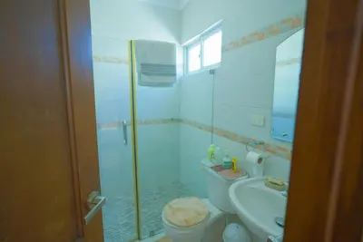 a bathroom with a shower and a toilet and a sink at Luxury Caribbean penthouse in Santo Domingo