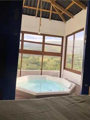 a large bath tub in a room with a window at Alto Nuevo