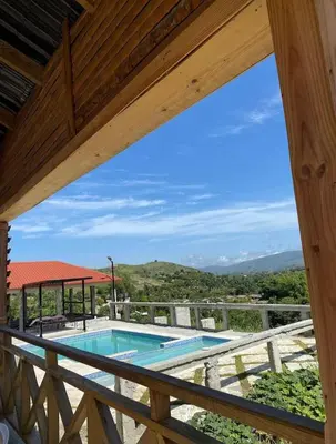 a view from the balcony of a house with a swimming pool at Alto Nuevo
