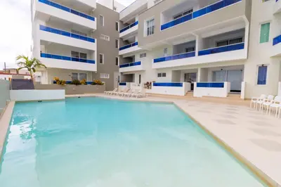 an empty swimming pool in front of a building at Caribbean Getaway 2BR at Caribbean Rose Bayahibe in San Rafael del Yuma