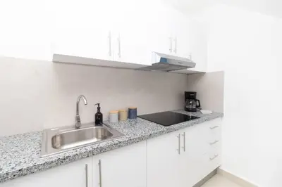 a kitchen with a sink and a counter top at Caribbean Getaway 2BR at Caribbean Rose Bayahibe in San Rafael del Yuma