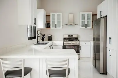 a kitchen with white cabinets and a white counter top at SwellHouseVilla in Cabrera