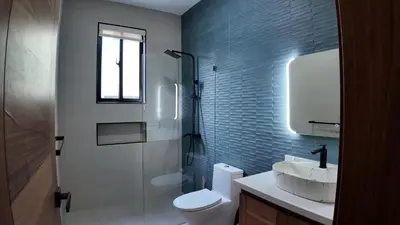 a bathroom with a toilet and a sink and a shower at Cigua Palmera 42 in Puerto Plata