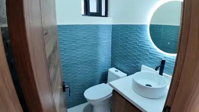 a bathroom with a white toilet and a sink at Cigua Palmera 42 in Puerto Plata