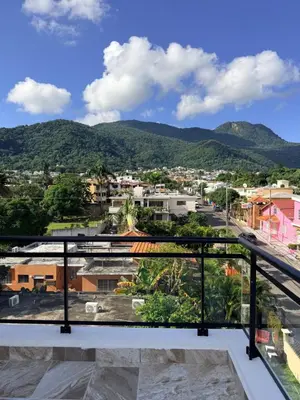 a view of the city from the balcony of a house at PF Hotel in San Felipe de Puerto Plata